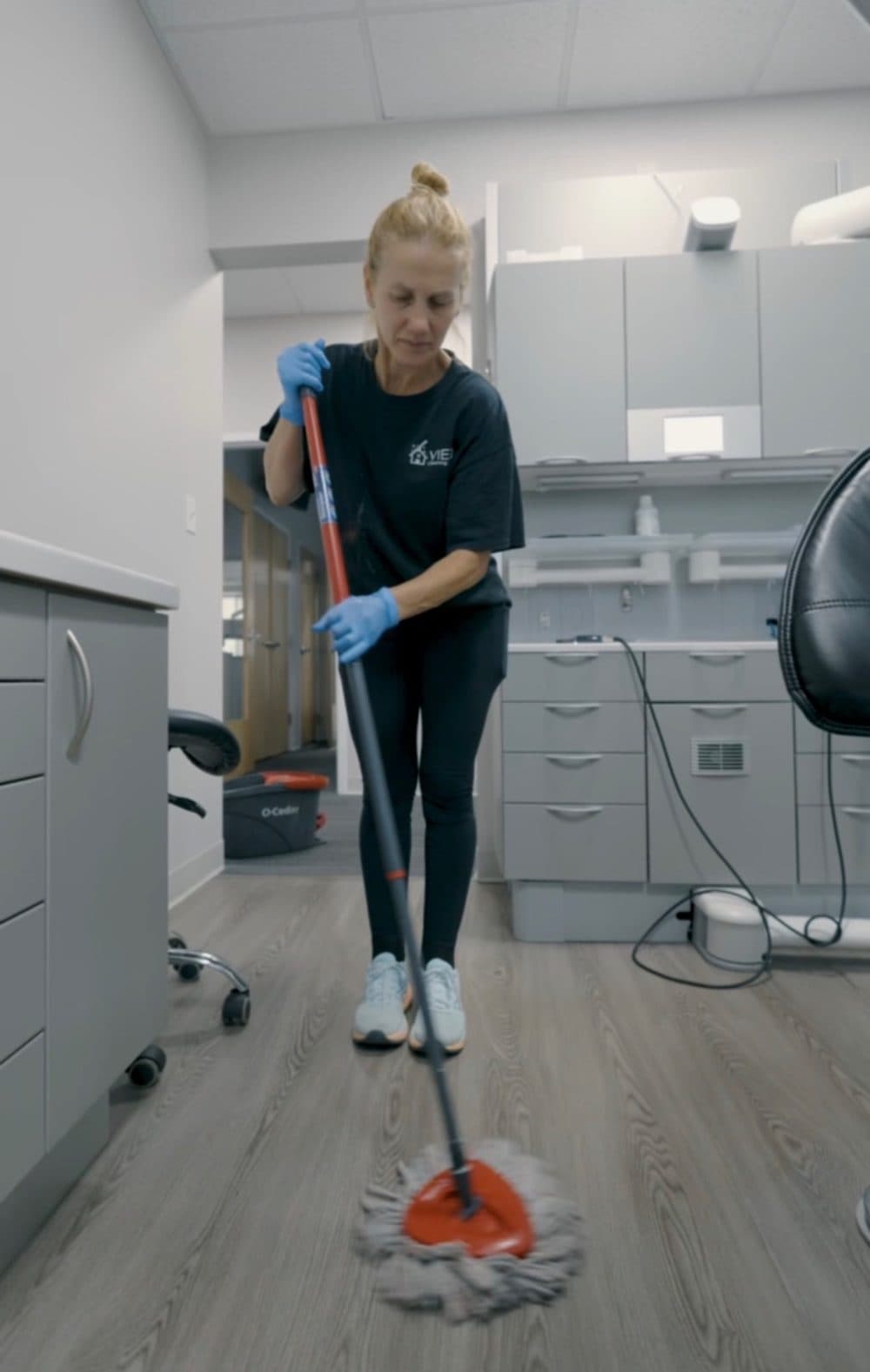 Viera Cleaning Solutions team member mopping a commercial office floor